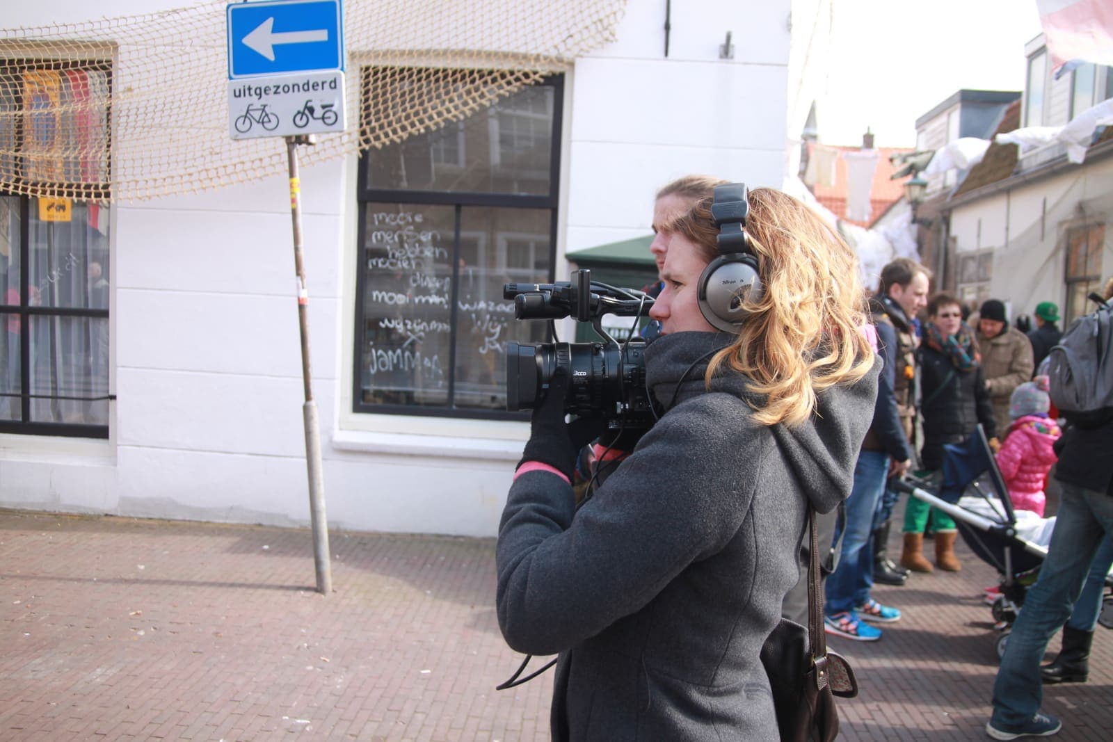 A location camera crew works around a mounted cinema camera