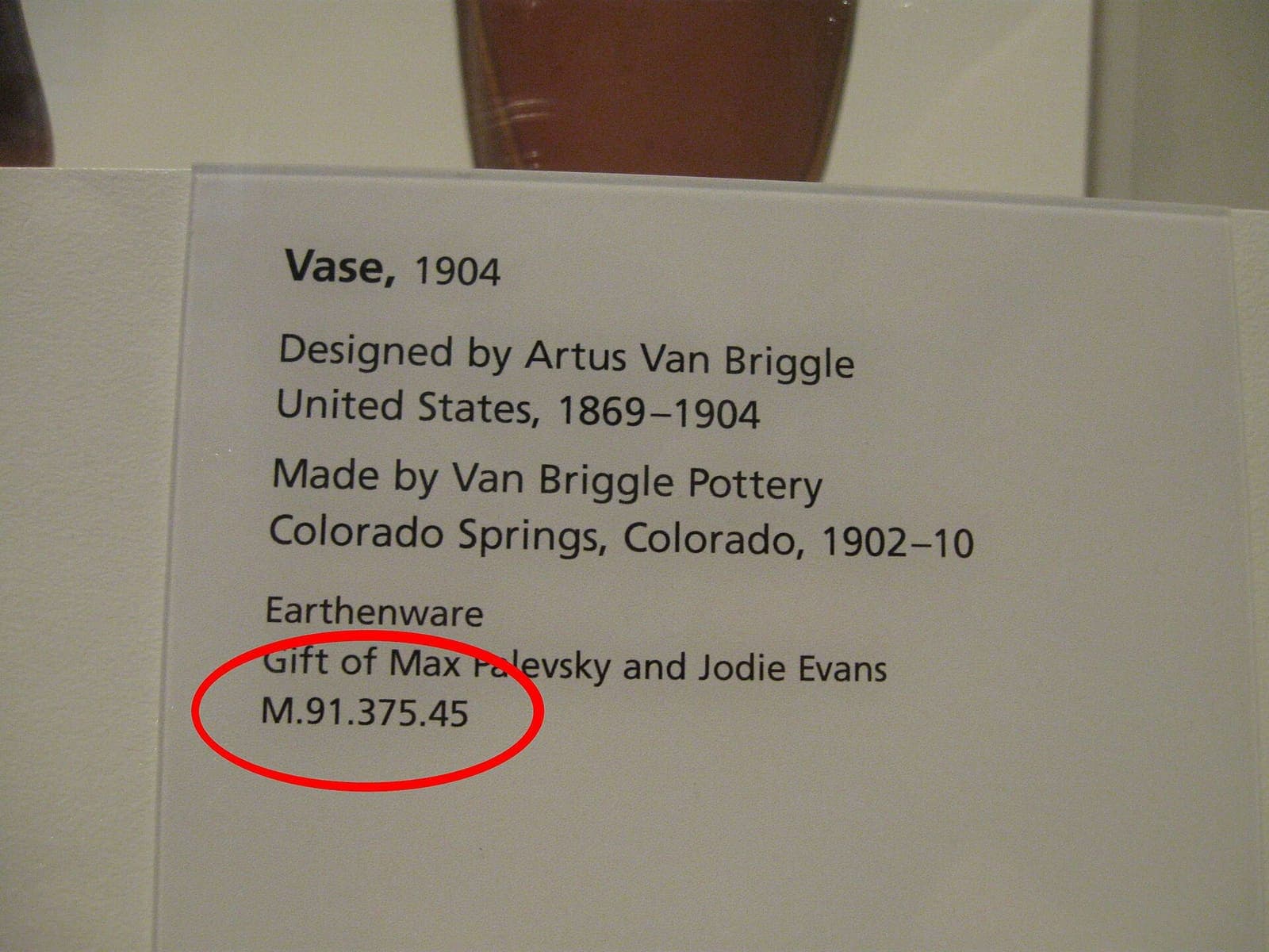 A museum accession-number label photographed at LACMA